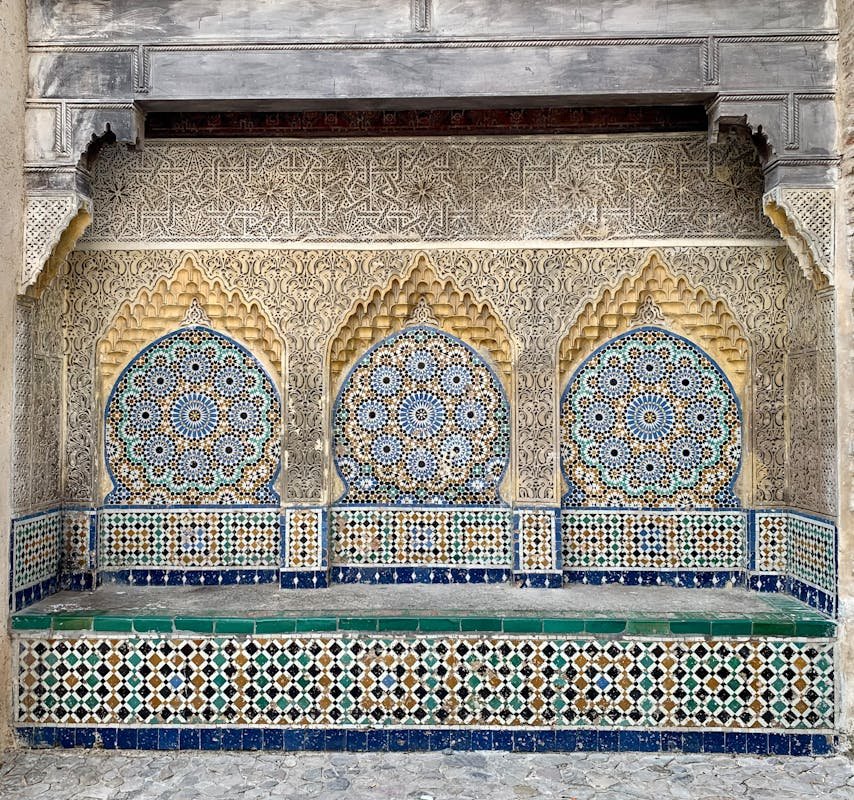 The Timeless Art of Moroccan Zellige: A Journey Through Mosaic Craftsmanship 2025 A detailed view of ornate Moroccan mosaic tiles with geometric patterns and carvings.