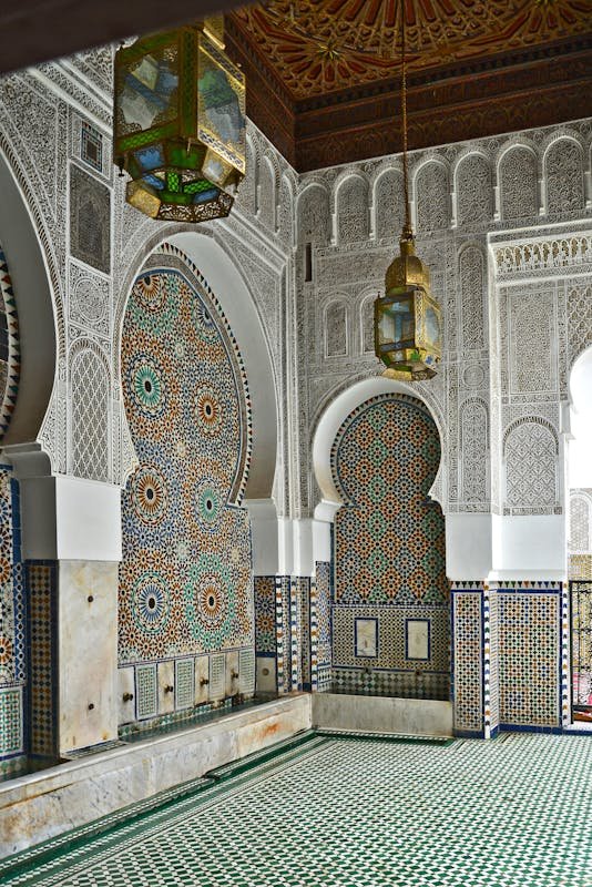 The Timeless Art of Moroccan Zellige: A Journey Through Mosaic Craftsmanship 2025 Beautiful Moroccan architecture showcasing detailed tile work and intricate patterns in Fès.