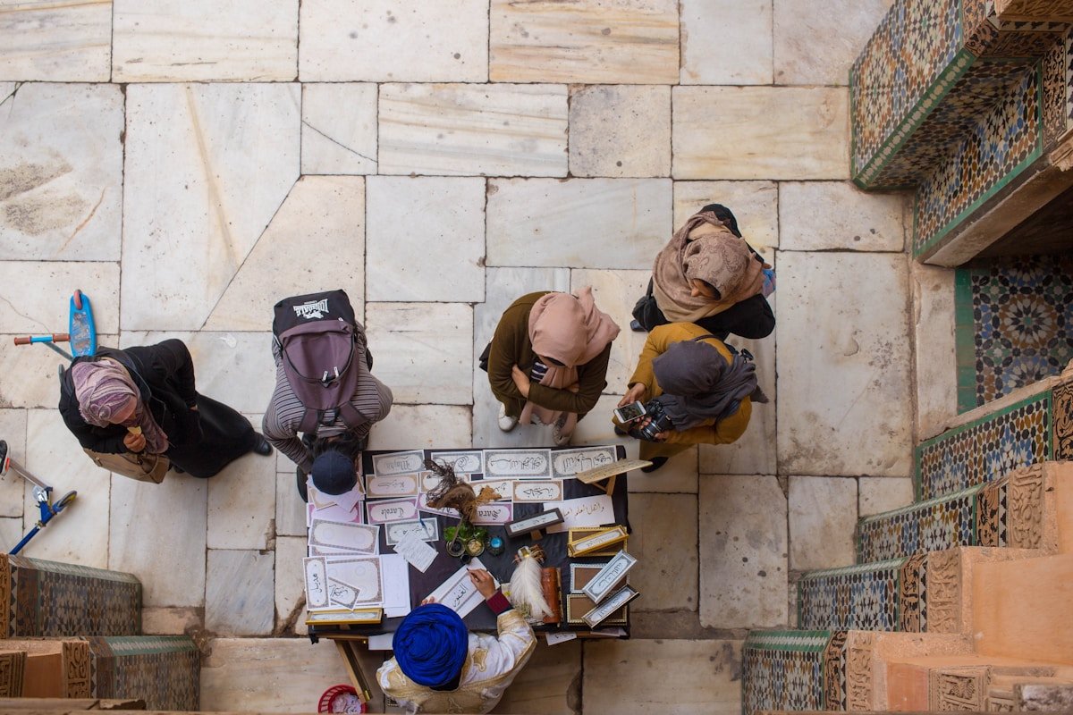 The Timeless Art of Moroccan Zellige: A Journey Through Mosaic Craftsmanship 2025 aerial view photography of people in front of man sitting next to brown wooden table