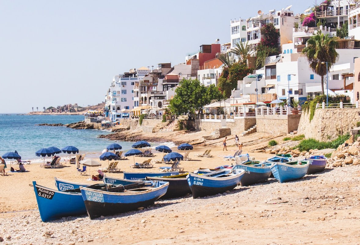 The Story Behind Morocco’s Imperial Cities: Tracing History Through Fez, Marrakech, Meknes, and Rabat 2025 blue boats in beach near city